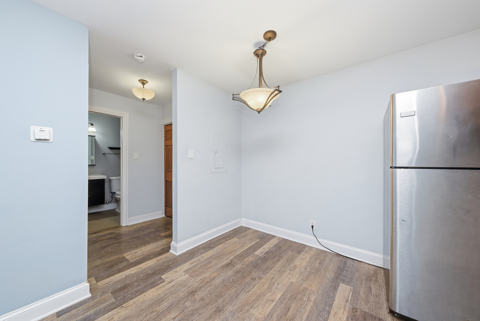 2300 Light Road, Unit 209 Oswego, IL 60543 - Photo 8 of 12 a view of empty room with wooden floor