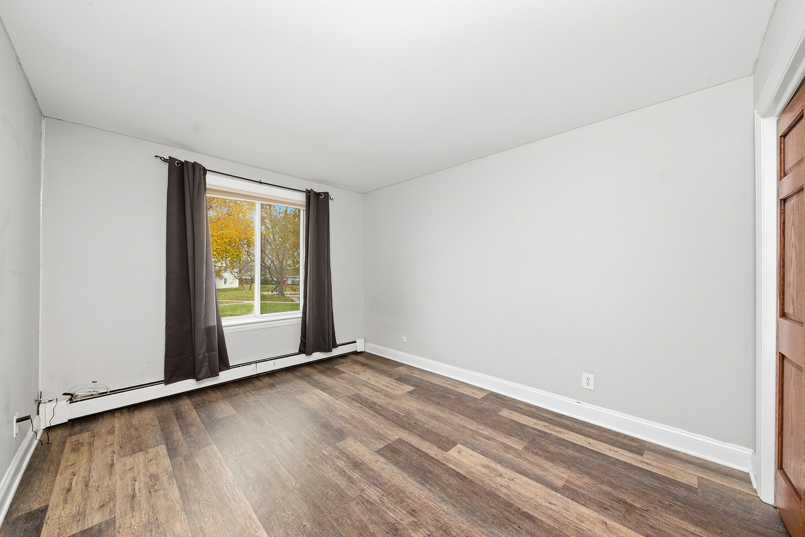 2300 Light Road, Unit 209 Oswego, IL 60543 - Photo 9 of 12 wooden floor in an empty room with a window