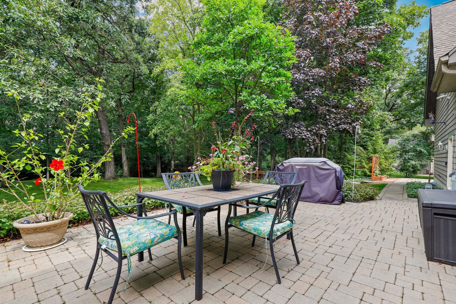 3048 Brampton Lane Dyer, IN 46311 - Photo 36 of 46 a view of a backyard with table and chairs potted plants and tree