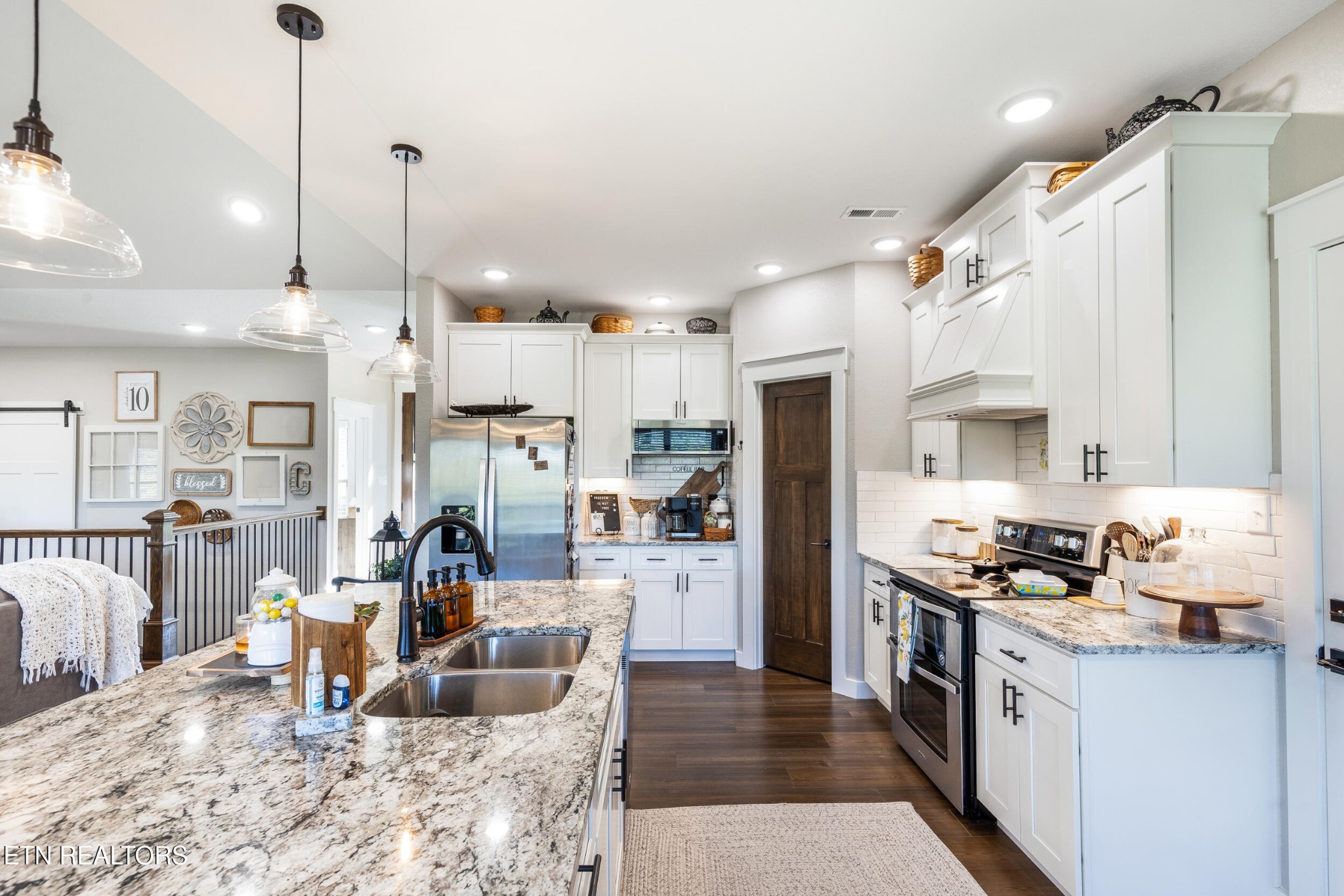 1866 Holston River Drive Rutledge, TN 37861 - Photo 15 of 54 a large kitchen with stainless steel appliances kitchen island granite countertop a refrigerator a stove a sink a dining table and chairs with wooden floor
