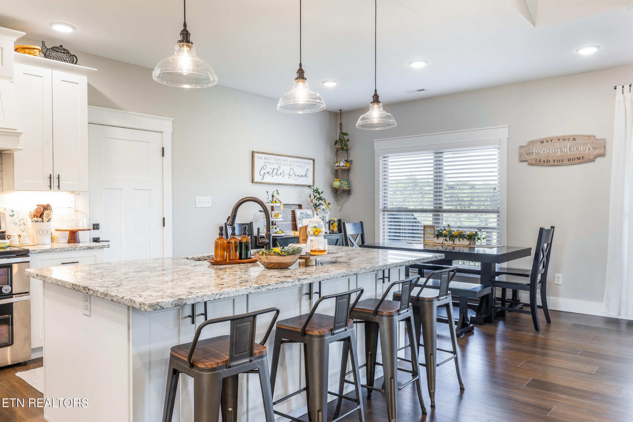 1866 Holston River Drive Rutledge, TN 37861 - Photo 16 of 54 a kitchen with stainless steel appliances granite countertop a dining table chairs and white cabinets