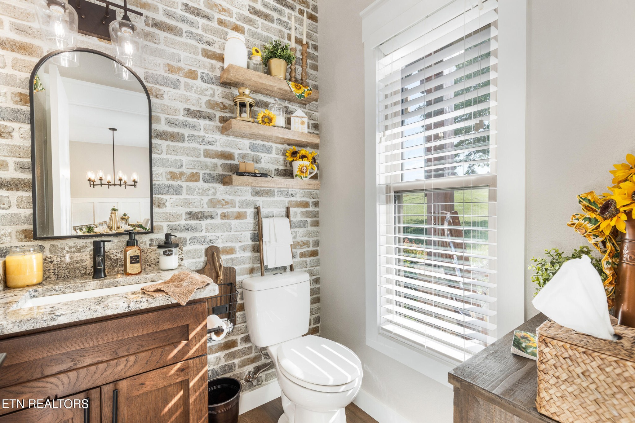 1866 Holston River Drive Rutledge, TN 37861 - Photo 18 of 54 a bathroom with a granite countertop toilet a sink and a window