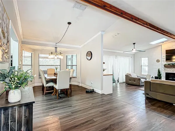a bedroom with a large bed and ceiling fan
