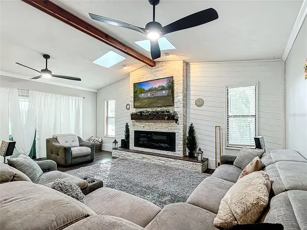 a view of a livingroom with workspace and a window