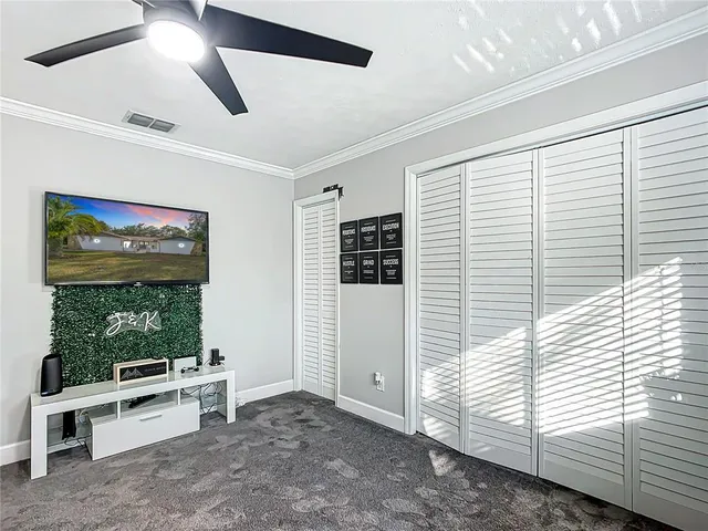 a view of a livingroom with workspace and a window