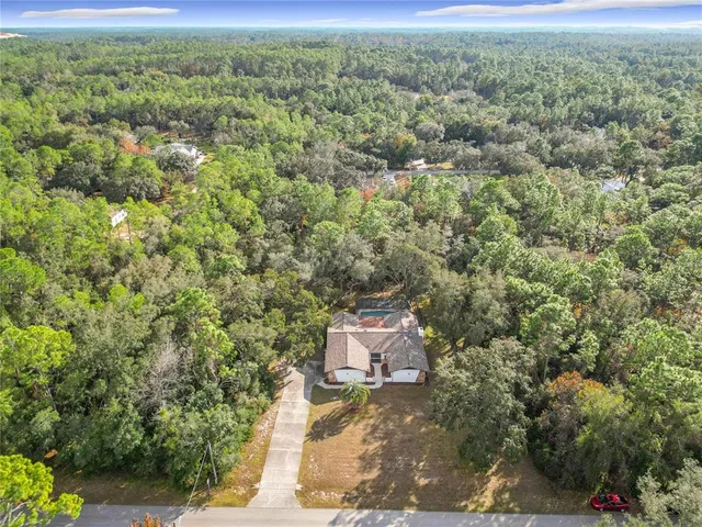 a view of a house with a garden and yard