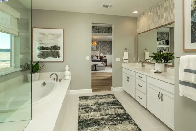 a bathroom with a tub sink and mirror