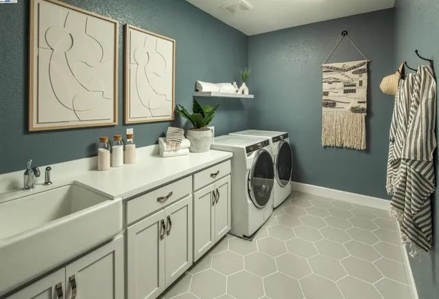 a utility room with a sink washer and dryer