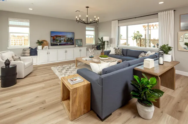 a living room with furniture a window and a dining table