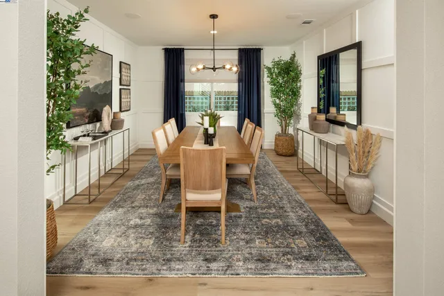 a dining room with wooden floor and large window