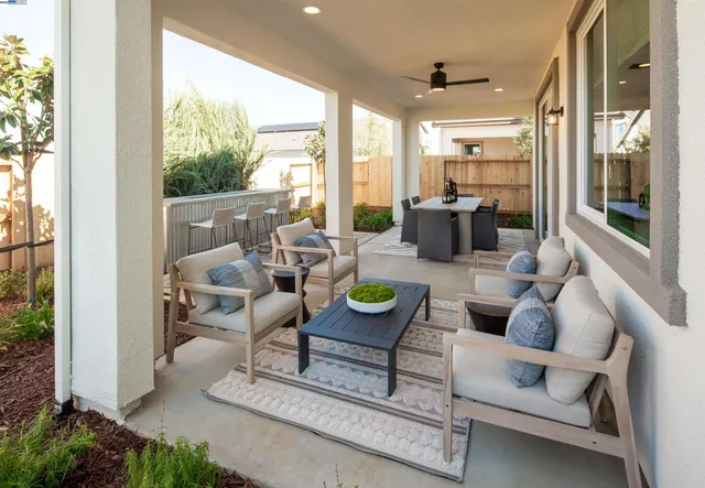 a living room with furniture and large windows