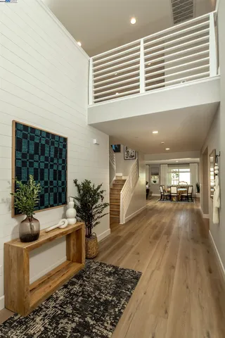 a living room with furniture floor to ceiling window and potted plant