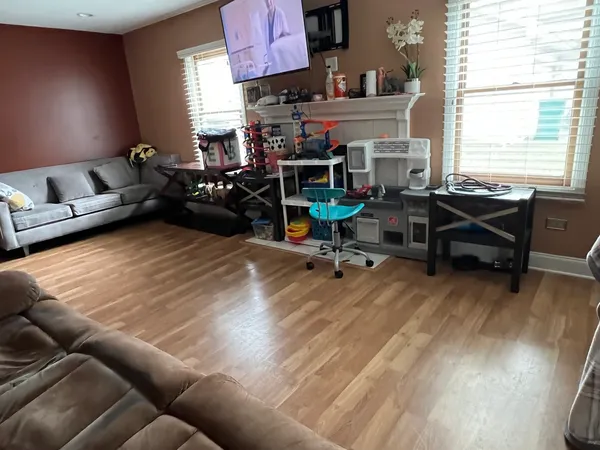 a work room with furniture and a wooden floor