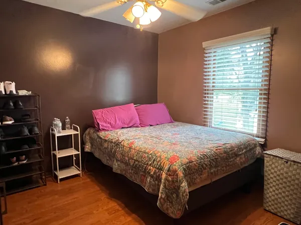 a bed sitting in a bedroom next to a window