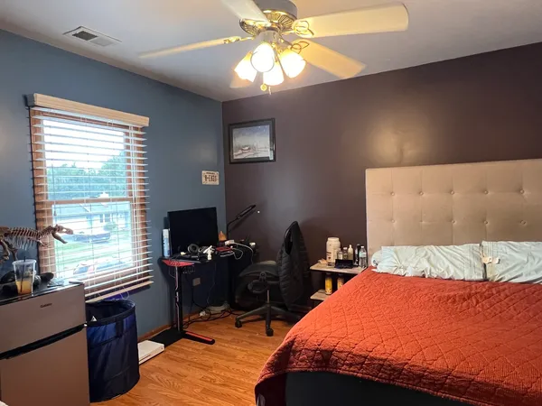 a bedroom with a bed and a window