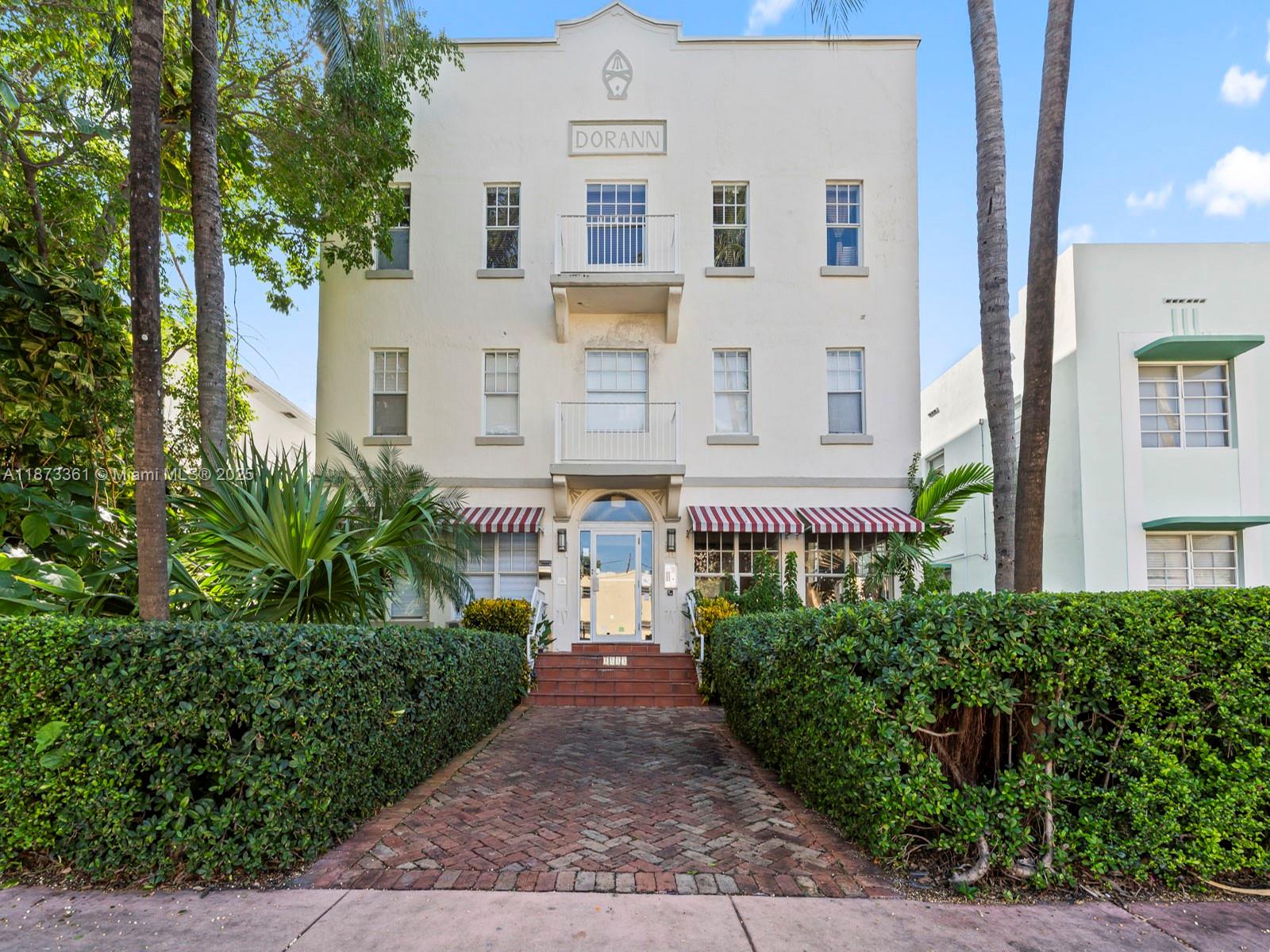 1244 Pennsylvania Avenue, Unit 302 Miami Beach, FL 33139 - Photo 1 of 13 a front view of a building with garden