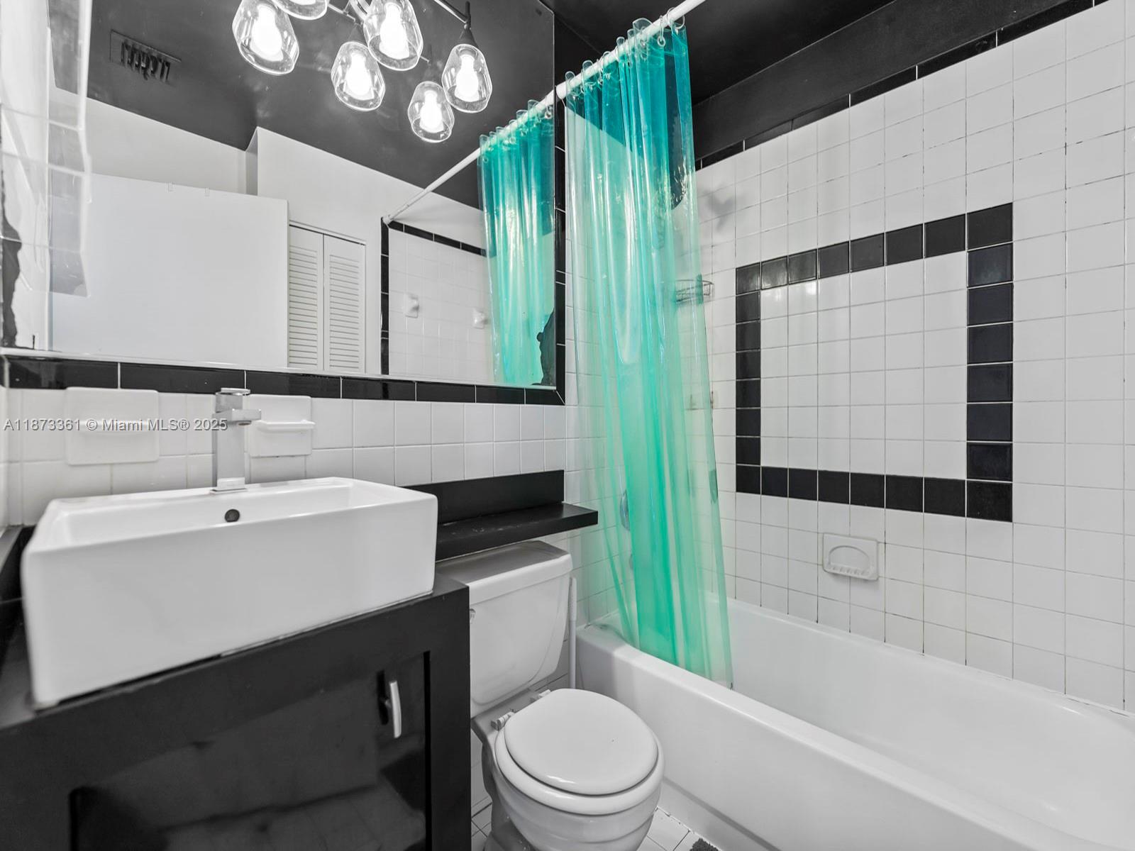 1244 Pennsylvania Avenue, Unit 302 Miami Beach, FL 33139 - Photo 11 of 13 a bathroom with a sink a toilet and shower