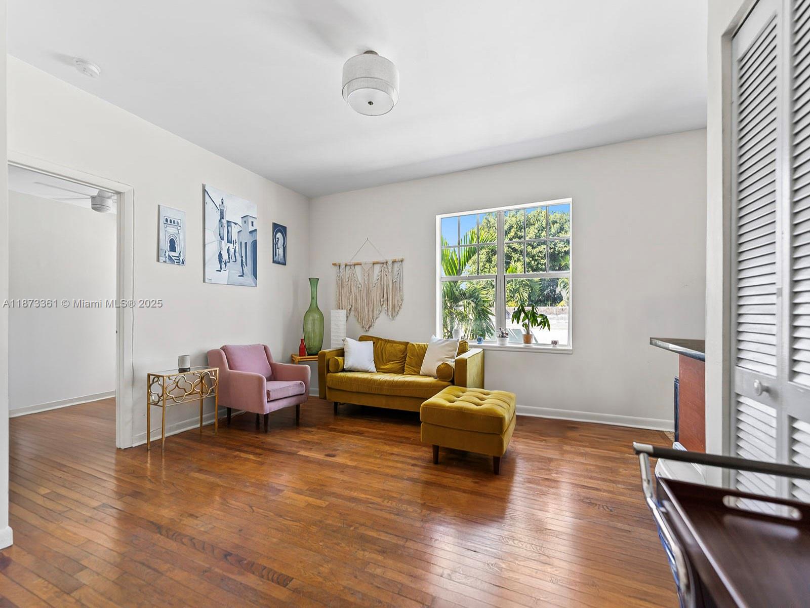 1244 Pennsylvania Avenue, Unit 302 Miami Beach, FL 33139 - Photo 12 of 13 a living room with furniture and a large window