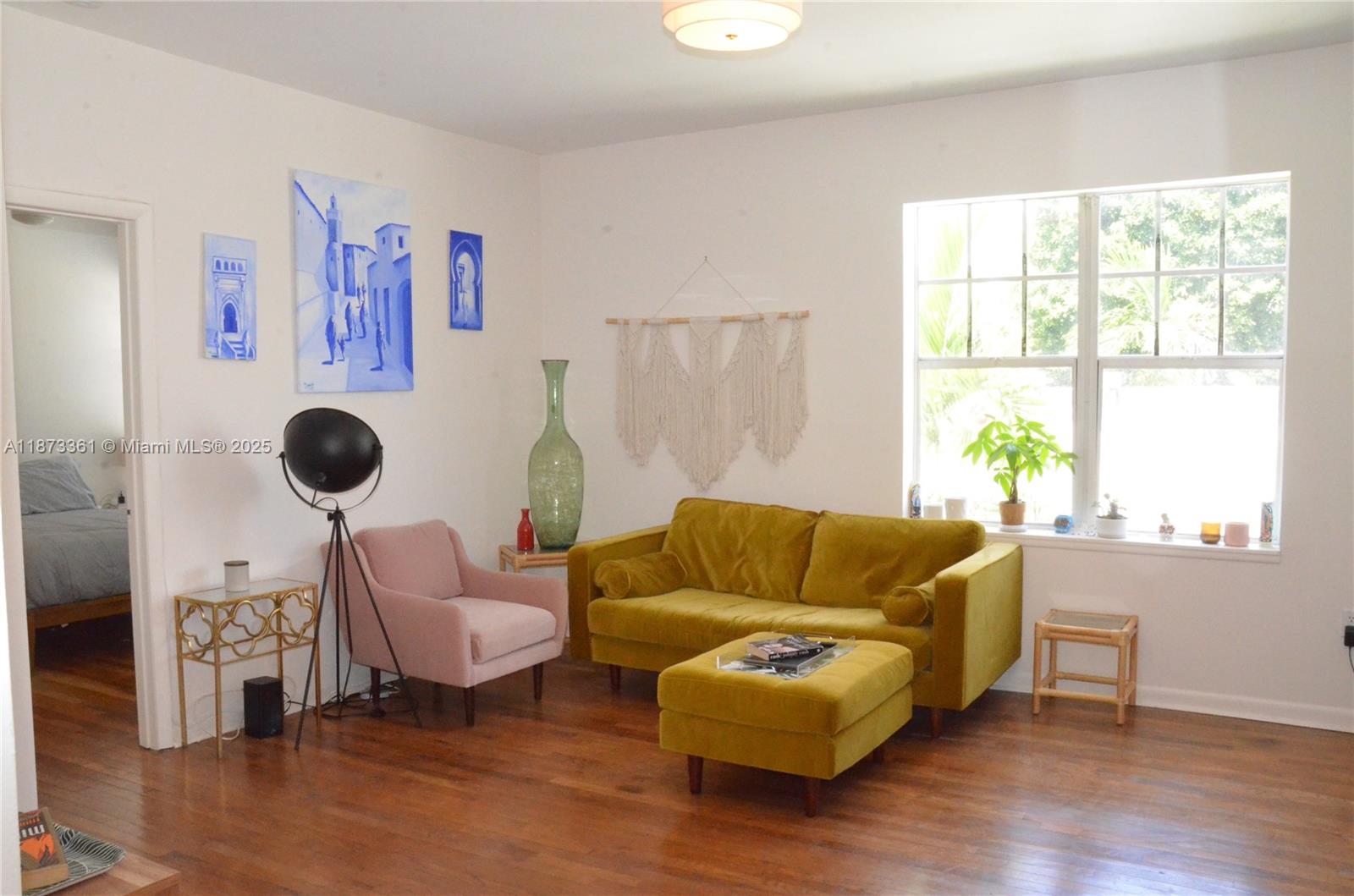 1244 Pennsylvania Avenue, Unit 302 Miami Beach, FL 33139 - Photo 5 of 13 a living room with furniture and a large window