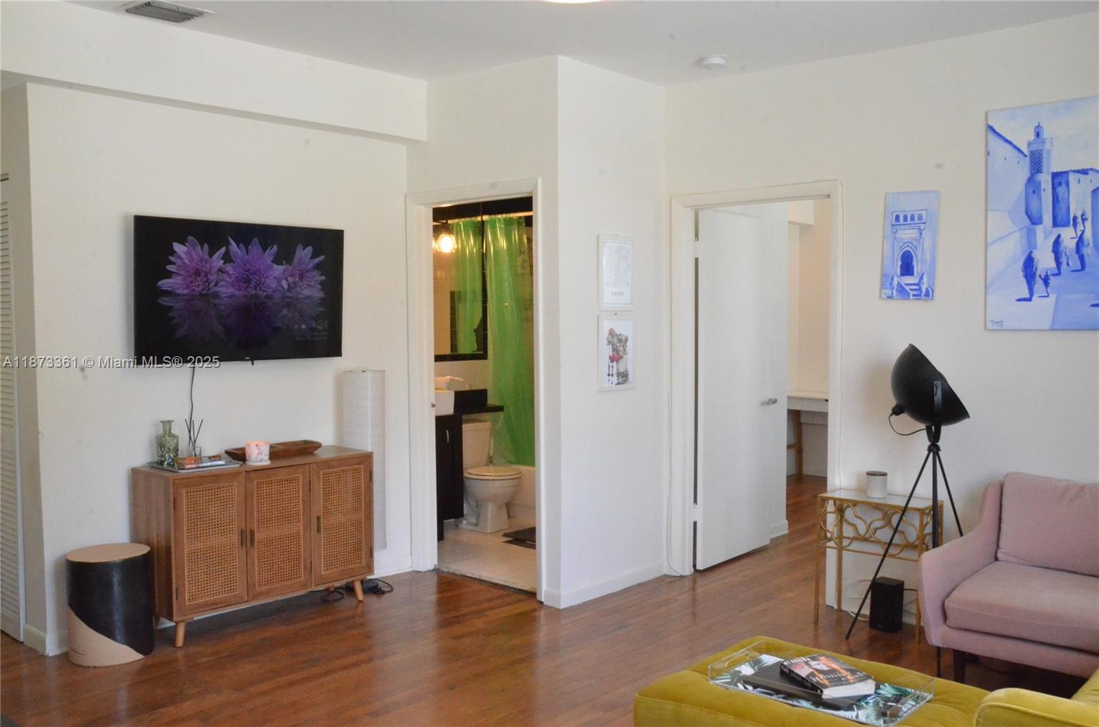 1244 Pennsylvania Avenue, Unit 302 Miami Beach, FL 33139 - Photo 6 of 13 a living room with furniture and a flat screen tv