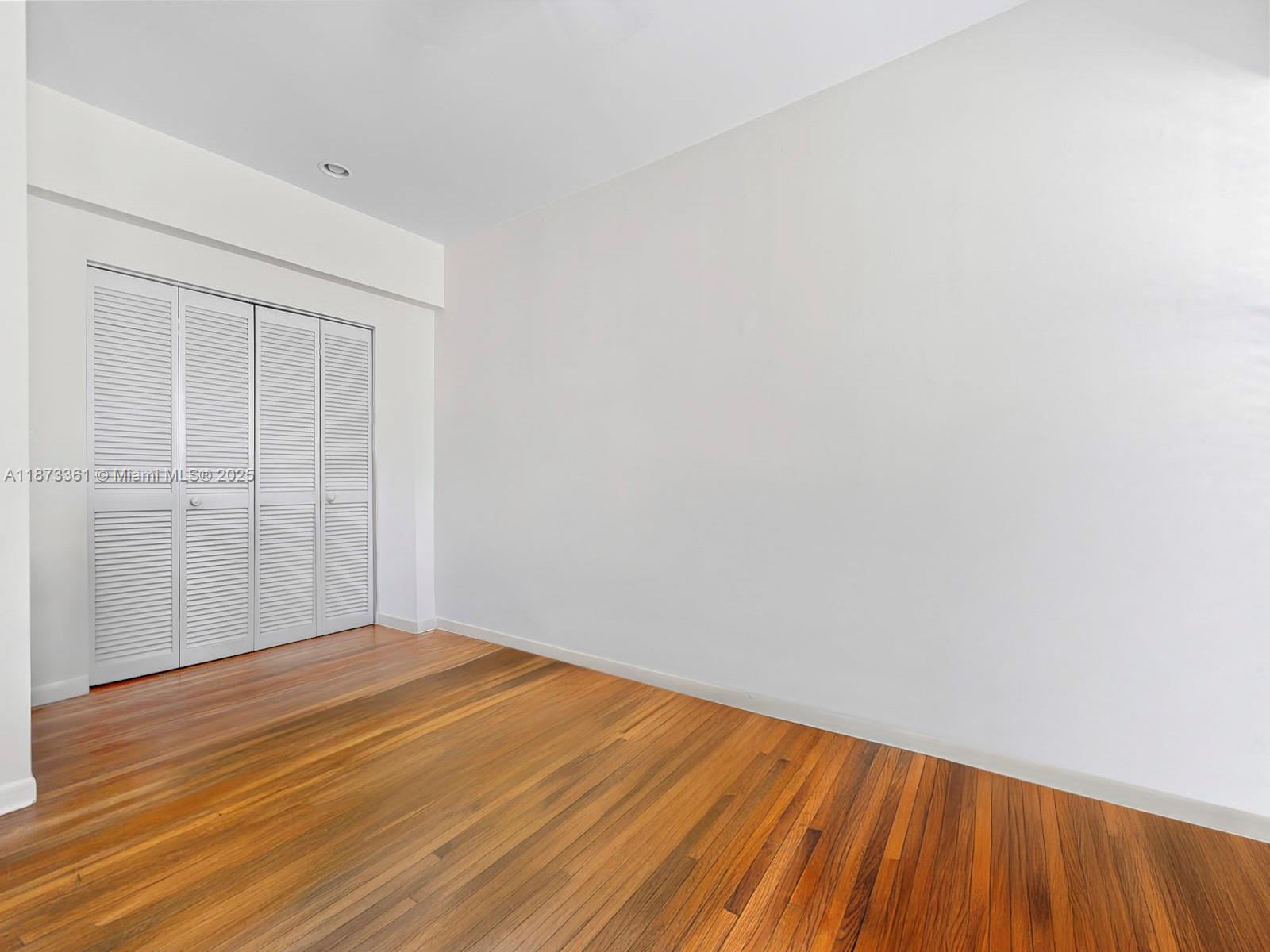 1244 Pennsylvania Avenue, Unit 302 Miami Beach, FL 33139 - Photo 9 of 13 a view of empty room with wooden floor
