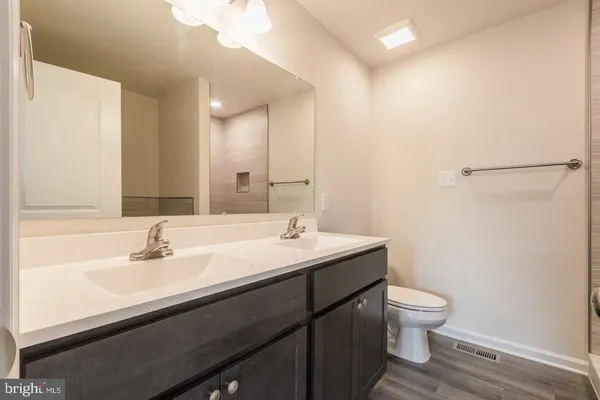 a bathroom with a sink toilet and mirror