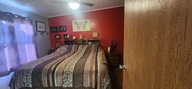 a bed room with a bed and a mirror