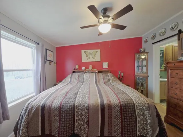 a bedroom with a large bed and a chandelier