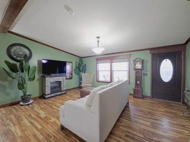 a living room with furniture a flat screen tv and a fireplace