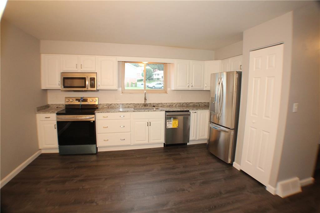 8112 A Nuttals Grove Road Pittsburgh, PA 15239 - Photo 8 of 20 a kitchen with a refrigerator stove and sink
