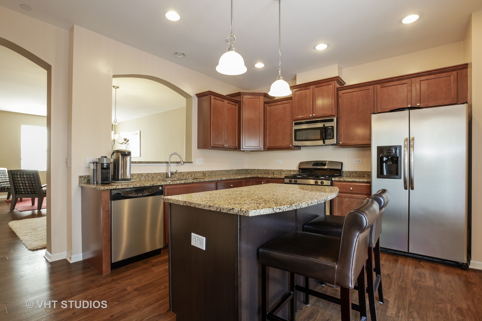 6826 Prairie Street Morton Grove, IL 60053 - Photo 2 of 16 a kitchen with stainless steel appliances granite countertop a sink a stove a refrigerator and a center island