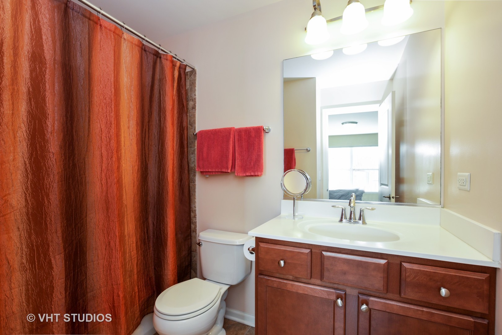 6826 Prairie Street Morton Grove, IL 60053 - Photo 12 of 16 a bathroom with a sink a toilet and shower curtain