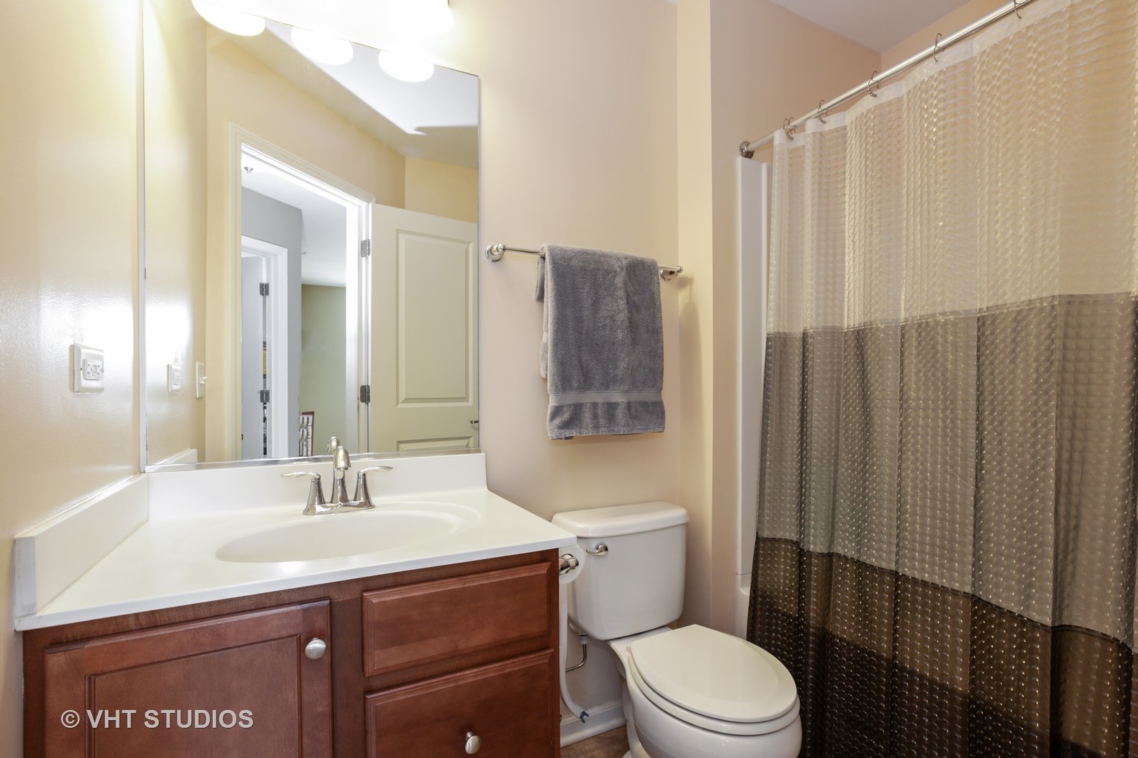 6826 Prairie Street Morton Grove, IL 60053 - Photo 13 of 16 a bathroom with a sink a toilet a mirror and shower curtain