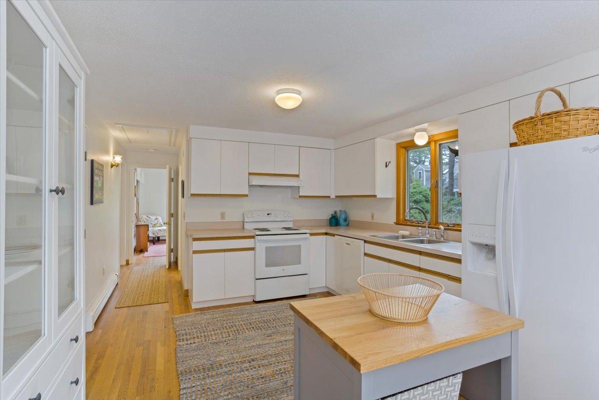 30 Warren Street Wellfleet, MA 02667 - Photo 12 of 47 a kitchen with a refrigerator a sink and a stove top oven