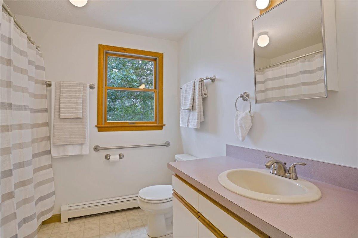 30 Warren Street Wellfleet, MA 02667 - Photo 16 of 47 a bathroom with a granite countertop toilet a sink and a mirror