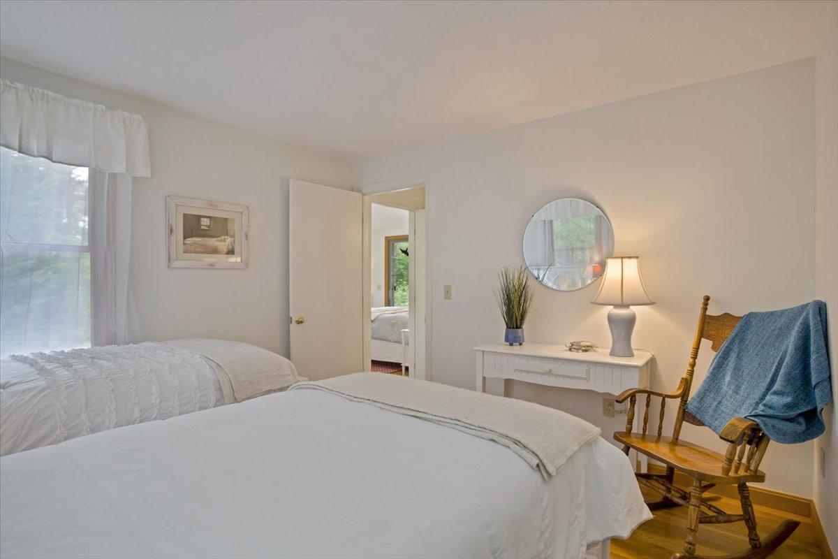 30 Warren Street Wellfleet, MA 02667 - Photo 17 of 47 a bedroom with a bed a mirror and a potted plant on table
