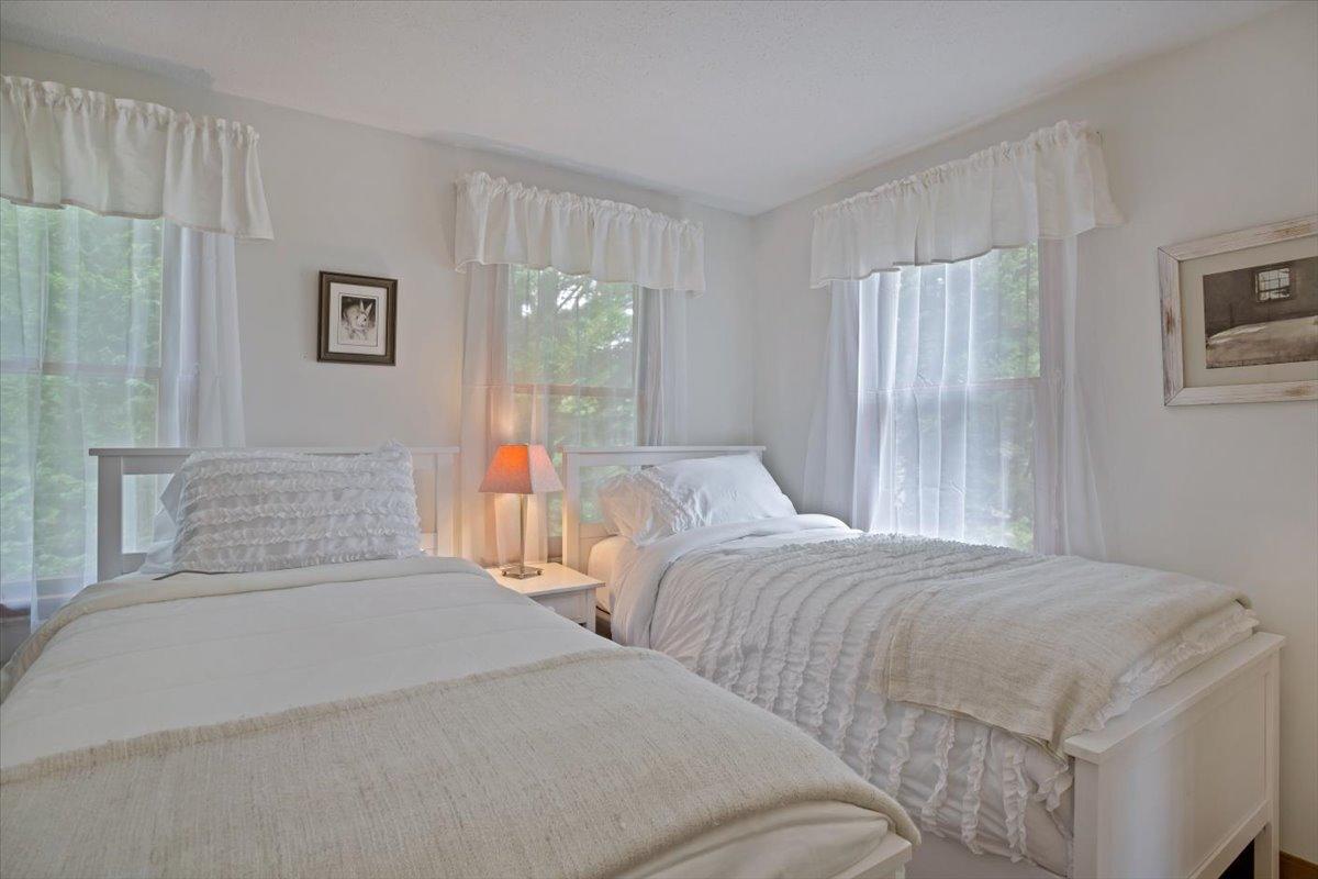 30 Warren Street Wellfleet, MA 02667 - Photo 19 of 47 a bedroom with two large bed and a chandelier