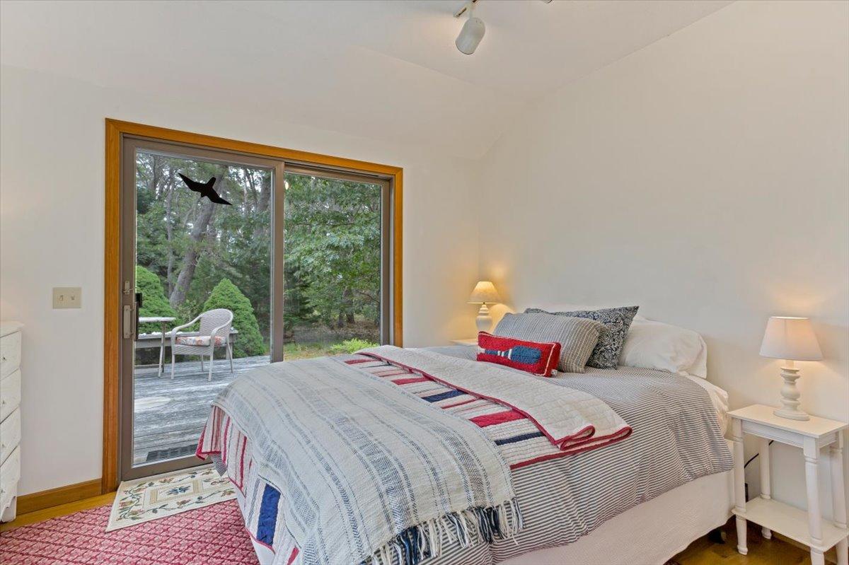 30 Warren Street Wellfleet, MA 02667 - Photo 22 of 47 a bedroom with a bed and wooden floor