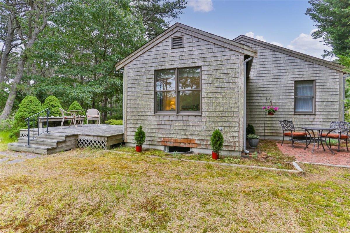 30 Warren Street Wellfleet, MA 02667 - Photo 26 of 47 a backyard of a house with yard and outdoor seating