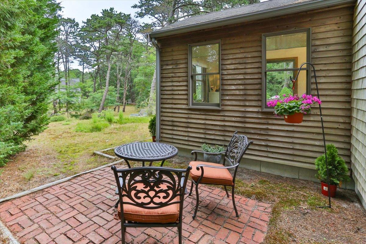 30 Warren Street Wellfleet, MA 02667 - Photo 40 of 47 a view of a chairs and table in backyard of the house