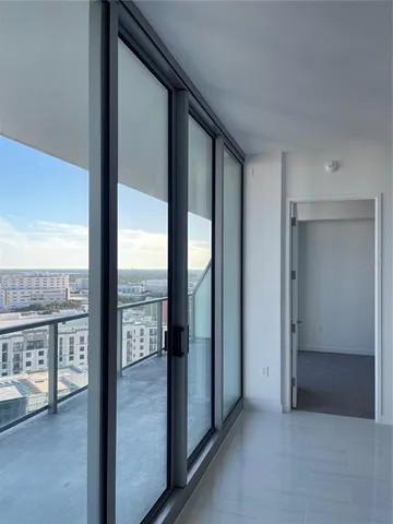 a view of a glass door and the balcony