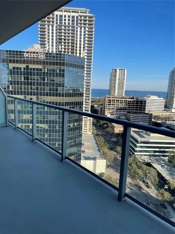 a view of balcony with floor to ceiling window and wooden floor