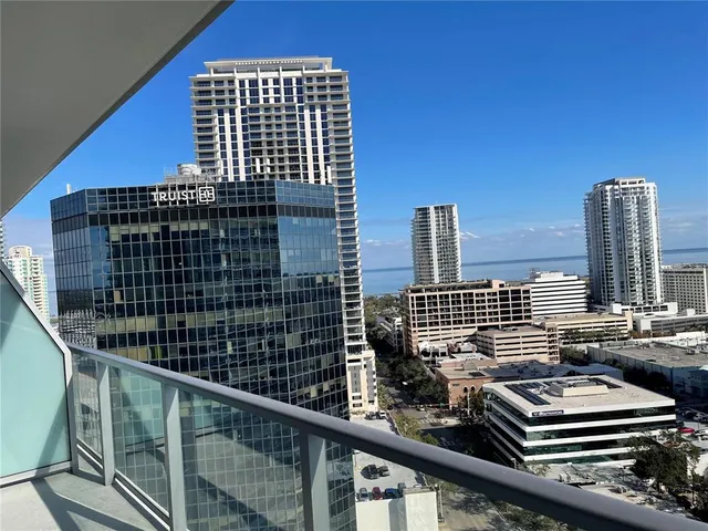 a view of a hallway with wooden floor and stairs