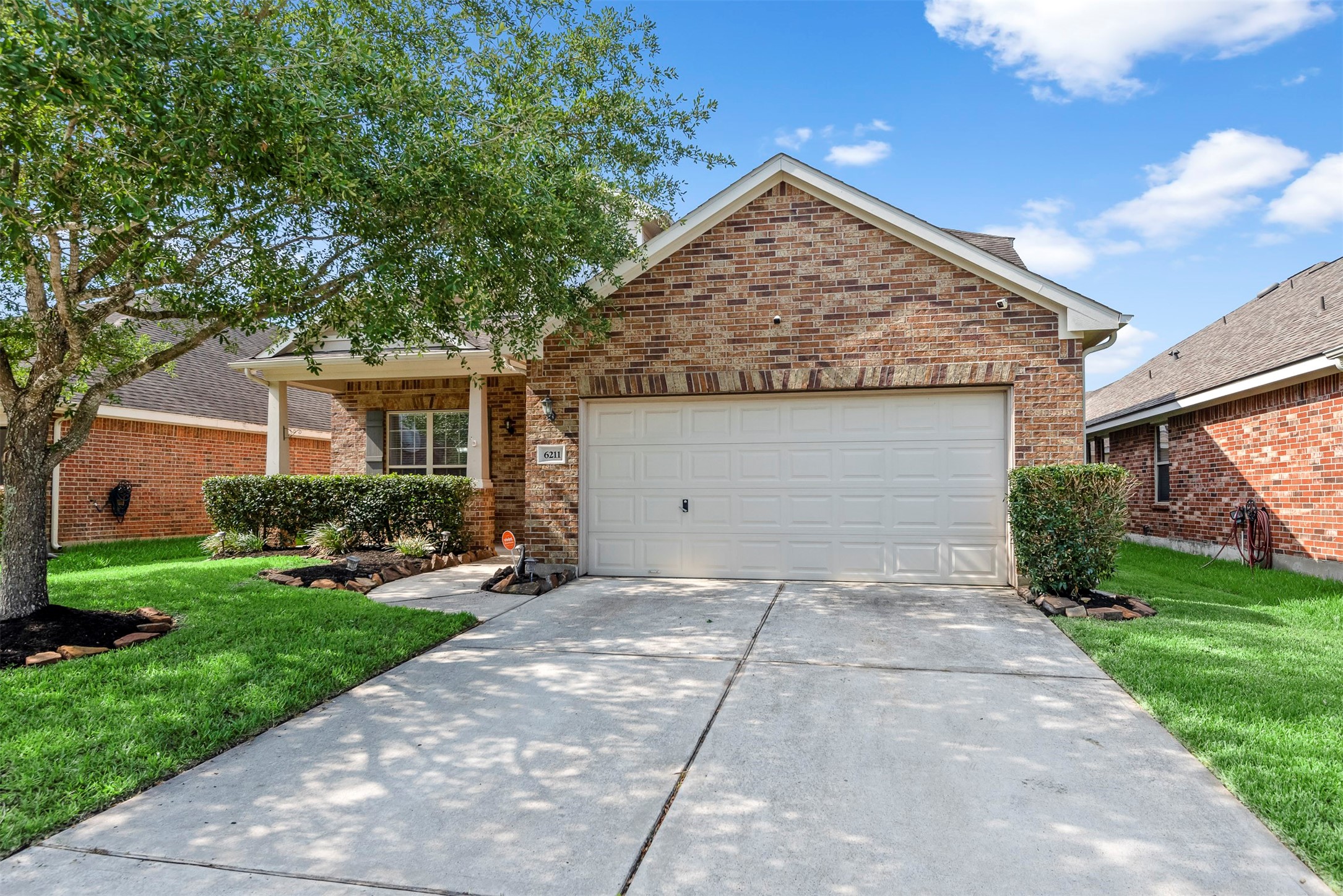Welcome to 6211 Flagg Ranch in Northcrest Village. Spacious driveway and inviting entry create a welcoming first impression.