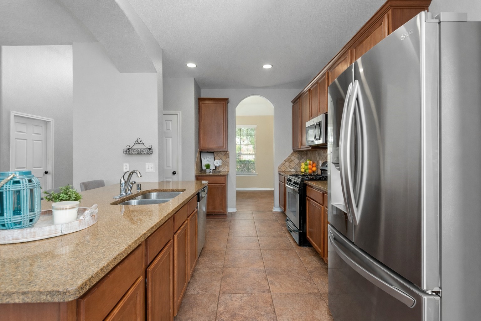 6211 Flagg Ranch Drive Spring, TX 77388 - Photo 12 of 36 Spacious kitchen featuring a large island with breakfast bar seating and ample counter space. Functional layout offers plenty of storage and easy flow throughout.