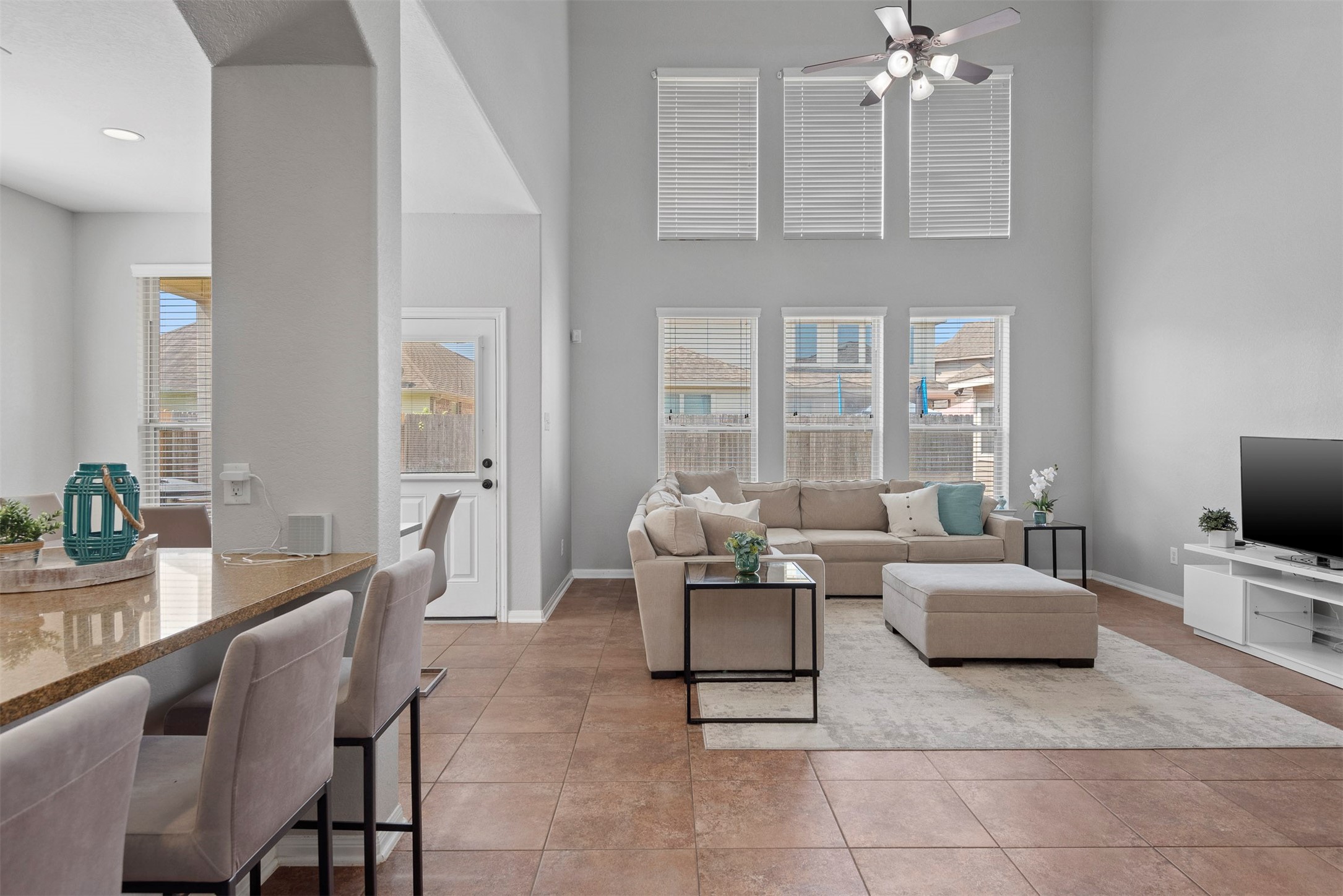 6211 Flagg Ranch Drive Spring, TX 77388 - Photo 19 of 36 Impressive two-story ceilings and a wall of windows fill the living room with natural light, creating a bright and airy feel.