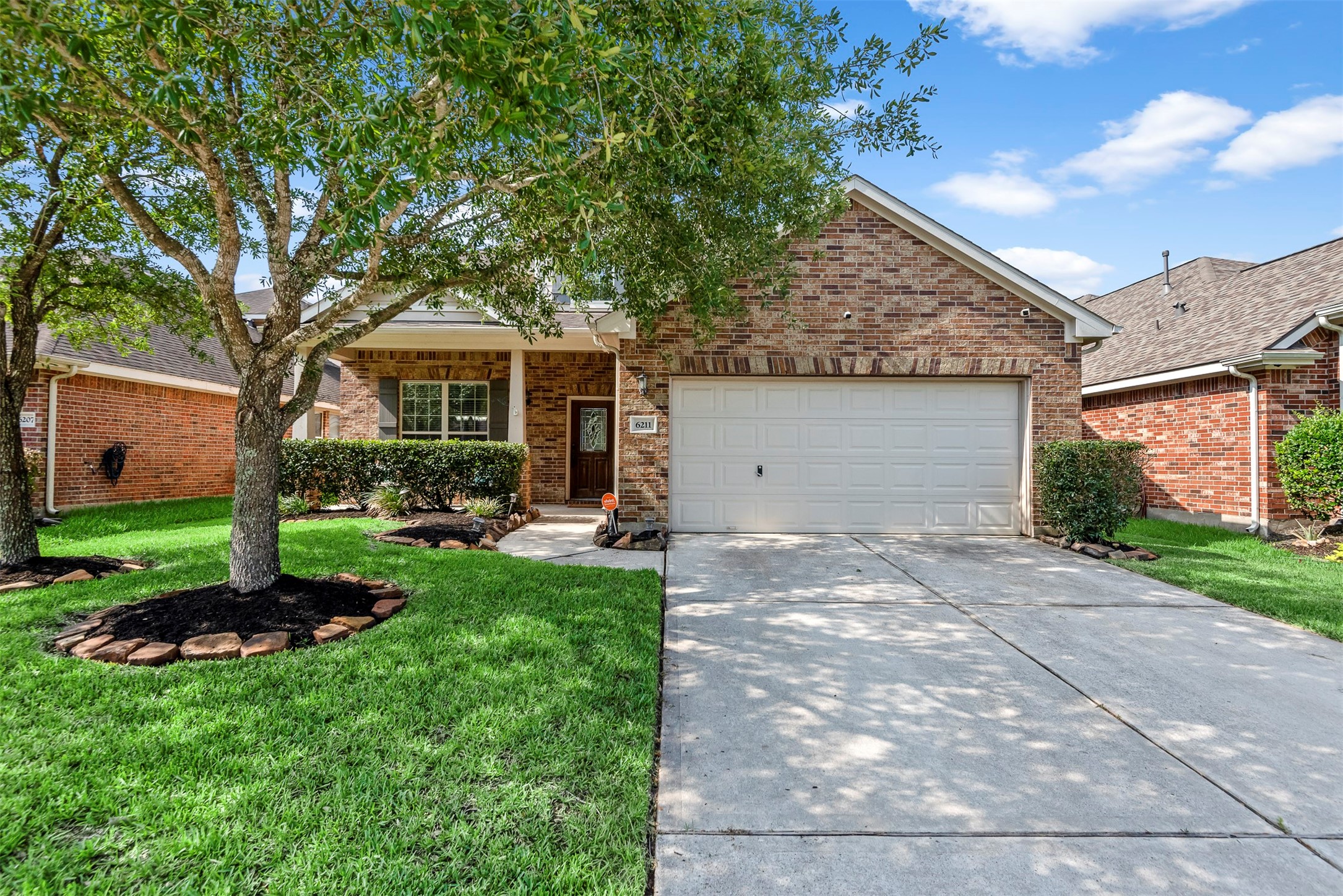 6211 Flagg Ranch Drive Spring, TX 77388 - Photo 2 of 36 Beautiful front yard with mature trees providing shade and character. This angle highlights the home’s inviting exterior and peaceful setting.