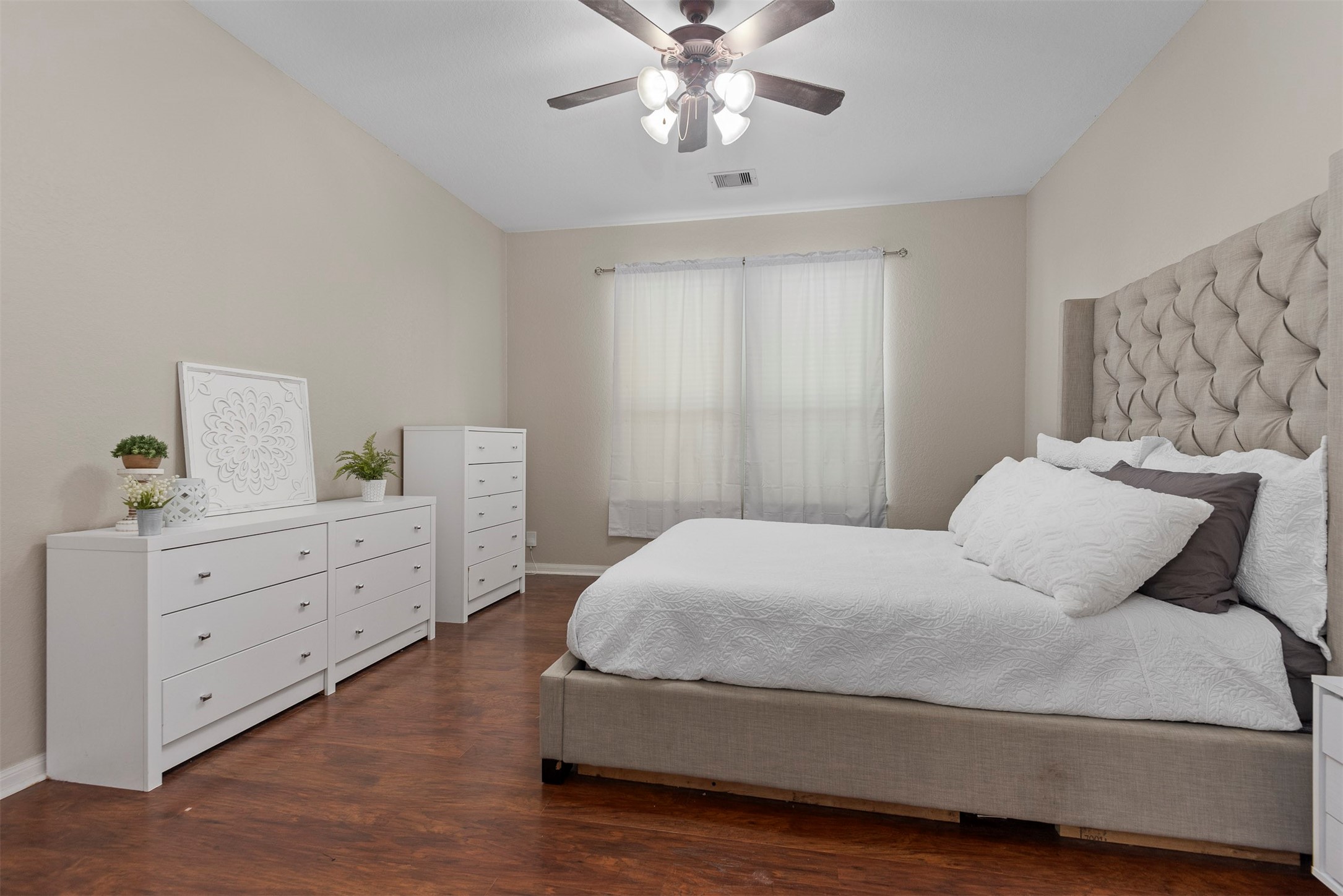 6211 Flagg Ranch Drive Spring, TX 77388 - Photo 23 of 36 Spacious primary bedroom with warm flooring and plenty of natural light, creating a comfortable retreat.