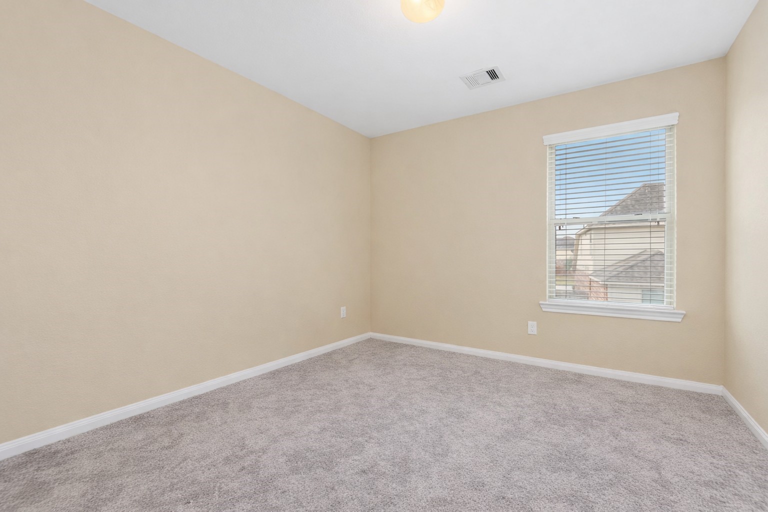 6211 Flagg Ranch Drive Spring, TX 77388 - Photo 30 of 36 Secondary bedroom conveniently located next to the game room, featuring neutral tones and great natural light.