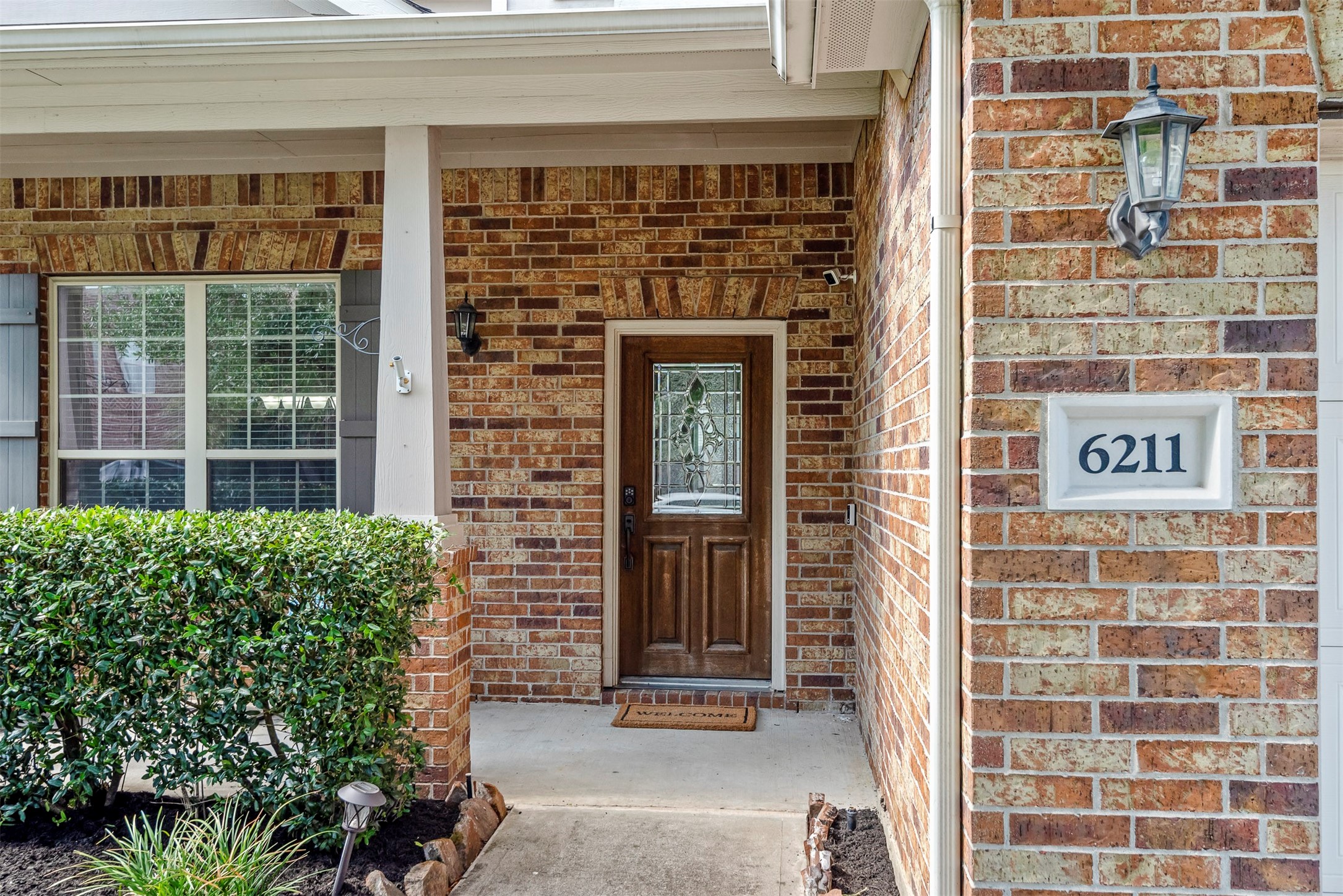 6211 Flagg Ranch Drive Spring, TX 77388 - Photo 4 of 36 Welcoming front entry with covered porch and charming brick exterior. A warm and inviting space that sets the tone as soon as you arrive.